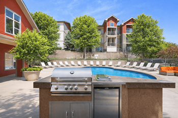 Outdoor kitchen with grill and pool area